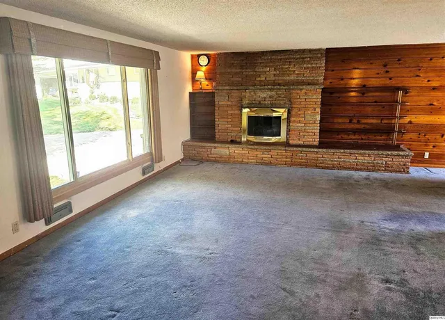 a view of an empty room with a fireplace