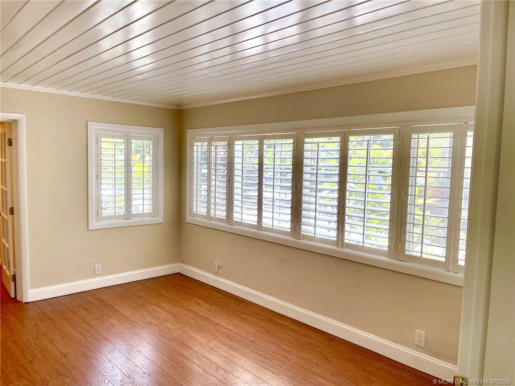4 Emarita Way Stuart, FL 34996 - Photo 17 of 47 a view of an empty room with wooden floor and a window