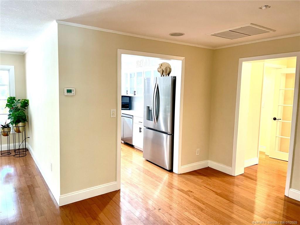 4 Emarita Way Stuart, FL 34996 - Photo 19 of 47 a view of a kitchen with wooden floor and a hallway