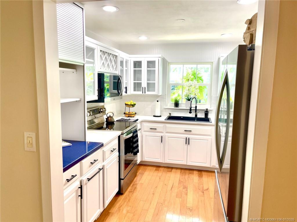 4 Emarita Way Stuart, FL 34996 - Photo 20 of 47 a kitchen with granite countertop white cabinets and white appliances