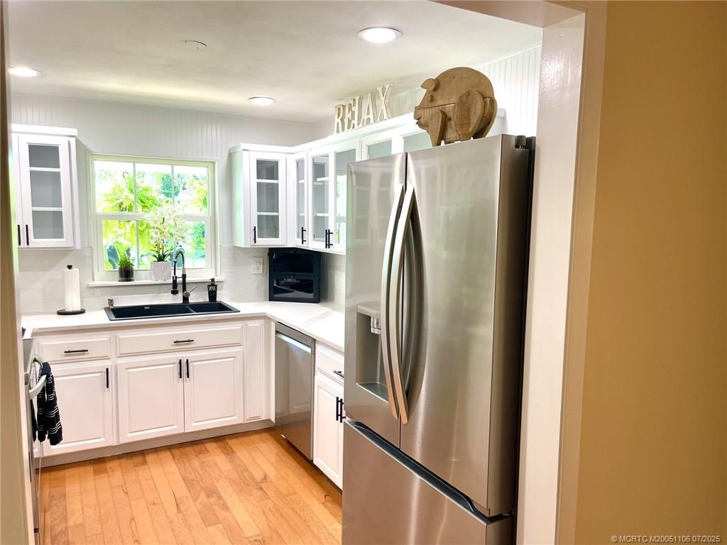 4 Emarita Way Stuart, FL 34996 - Photo 21 of 47 a kitchen with stainless steel appliances granite countertop a refrigerator and a sink