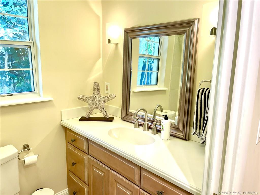 4 Emarita Way Stuart, FL 34996 - Photo 23 of 47 a bathroom with a sink a mirror and a toilet