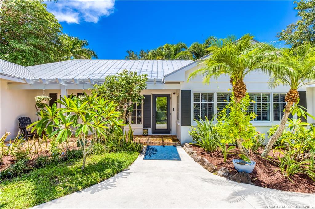 4 Emarita Way Stuart, FL 34996 - Photo 3 of 47 a view of a house with potted plants and a large tree