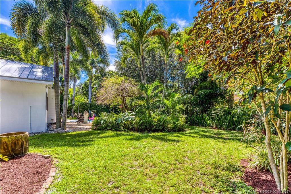 4 Emarita Way Stuart, FL 34996 - Photo 43 of 47 a view of a backyard with plants and large trees