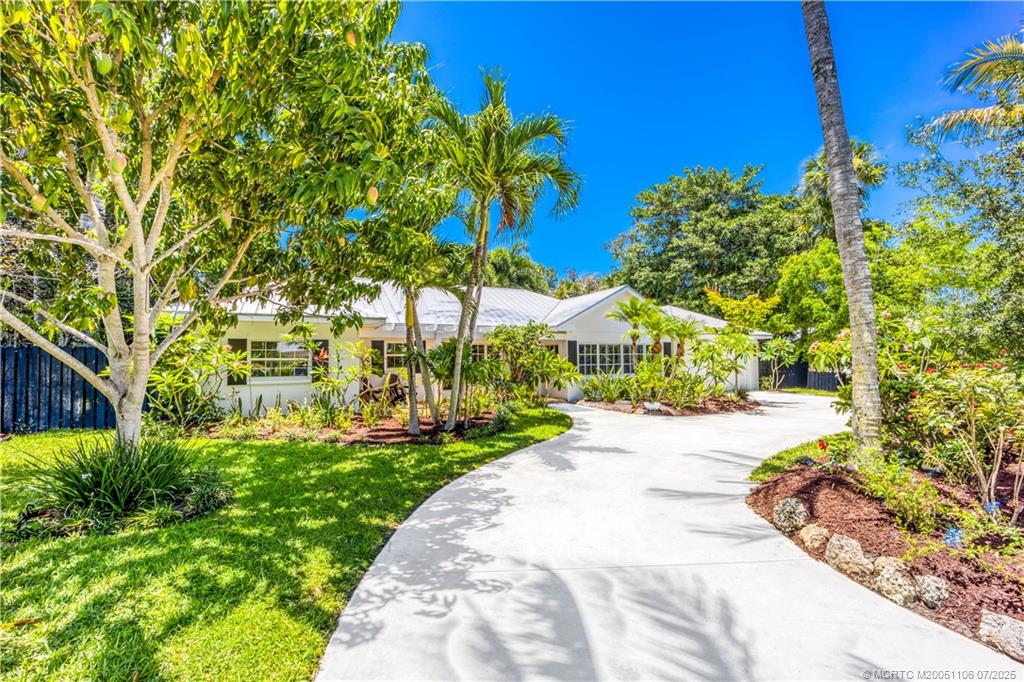 4 Emarita Way Stuart, FL 34996 - Photo 5 of 47 a view of a garden with a building in the background