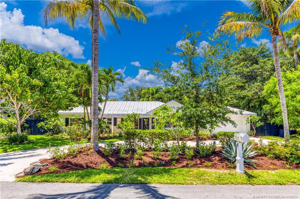 4 Emarita Way Stuart, FL 34996 - Photo 9 of 47 a view of a patio with table and chairs under an umbrella