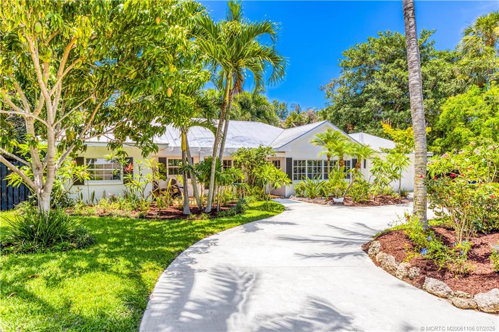 4 Emarita Way Stuart, FL 34996 - Photo 10 of 47 a front view of a house with a garden