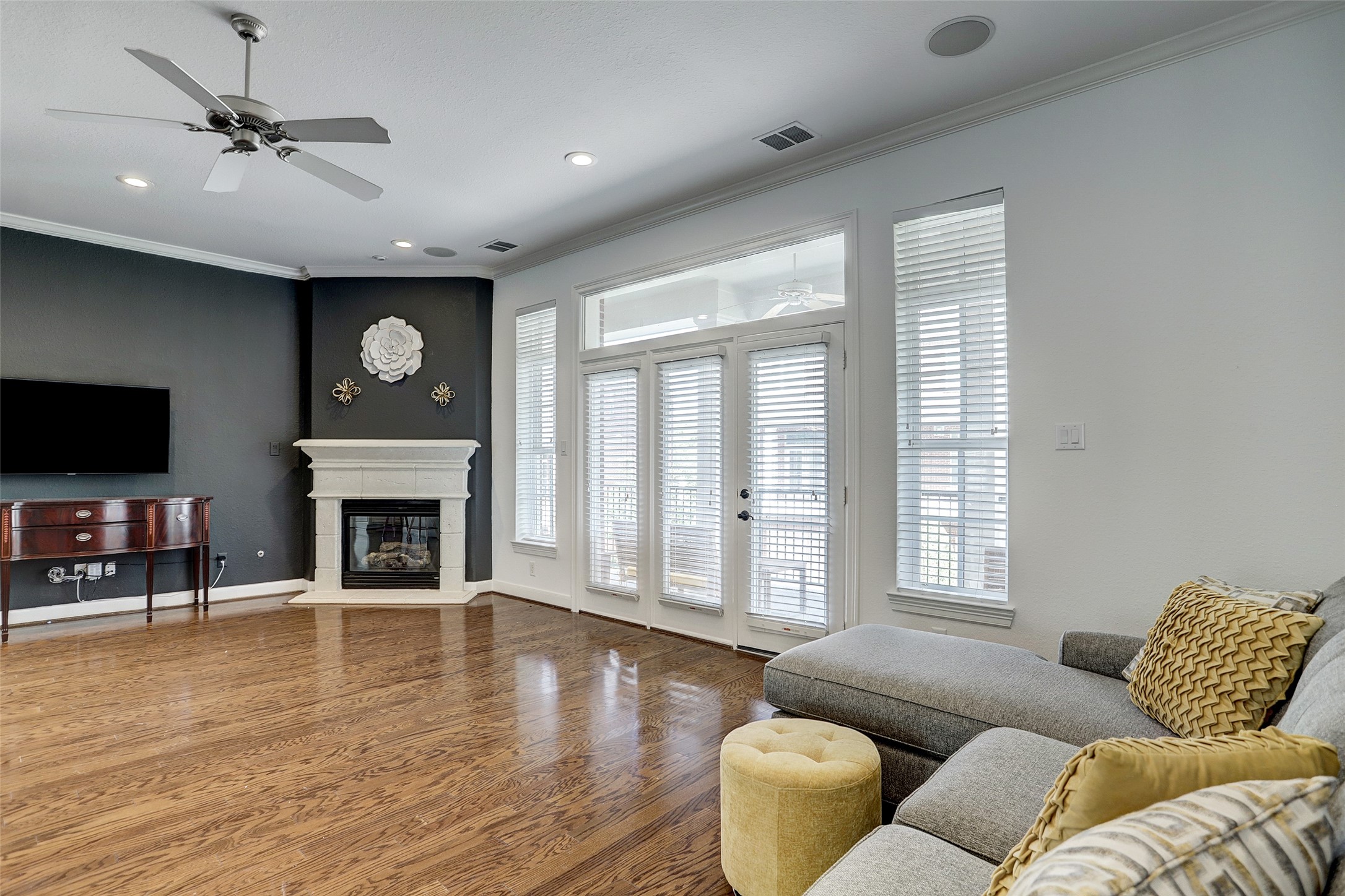 10 Shell Port Square The Woodlands, TX 77380 - Photo 15 of 31 a living room with furniture a fireplace and a flat screen tv