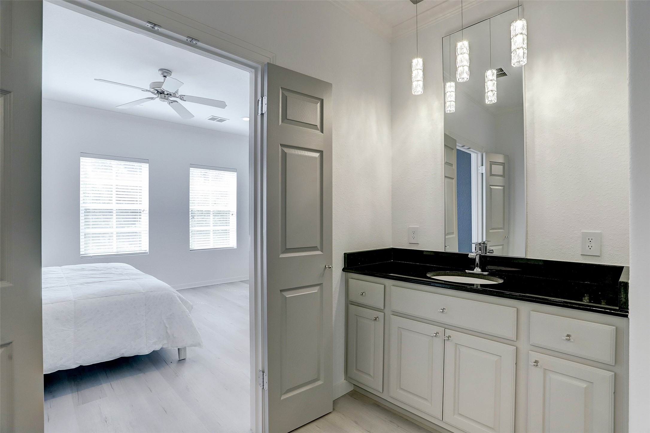 10 Shell Port Square The Woodlands, TX 77380 - Photo 24 of 31 a bathroom with a granite countertop sink a vanity and a mirror
