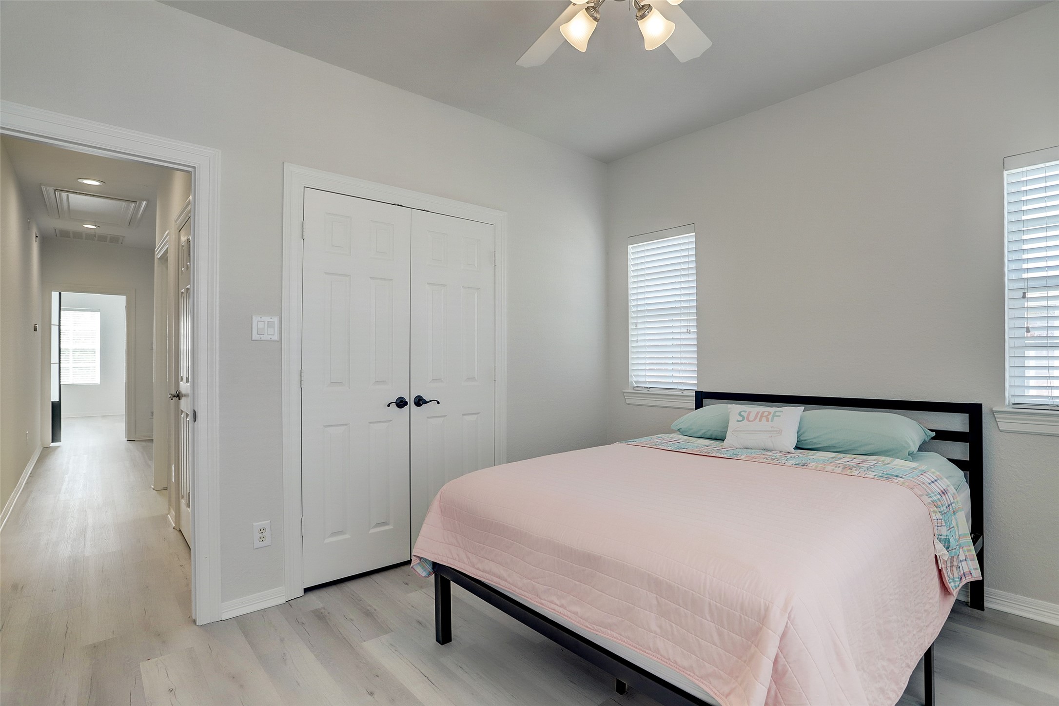 10 Shell Port Square The Woodlands, TX 77380 - Photo 27 of 31 a bedroom with a bed and a chandelier
