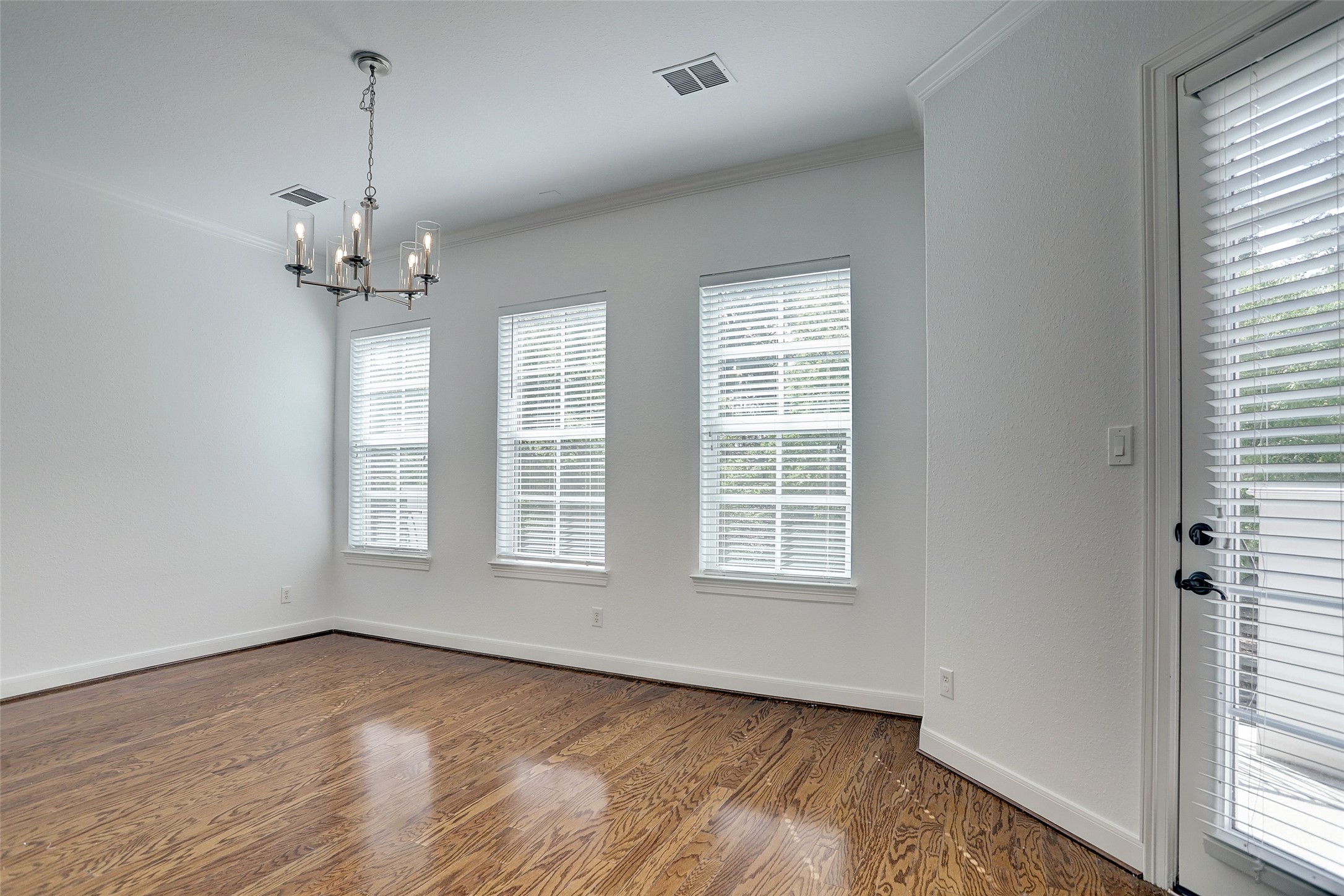 10 Shell Port Square The Woodlands, TX 77380 - Photo 10 of 31 a view of an empty room with a window and wooden floor