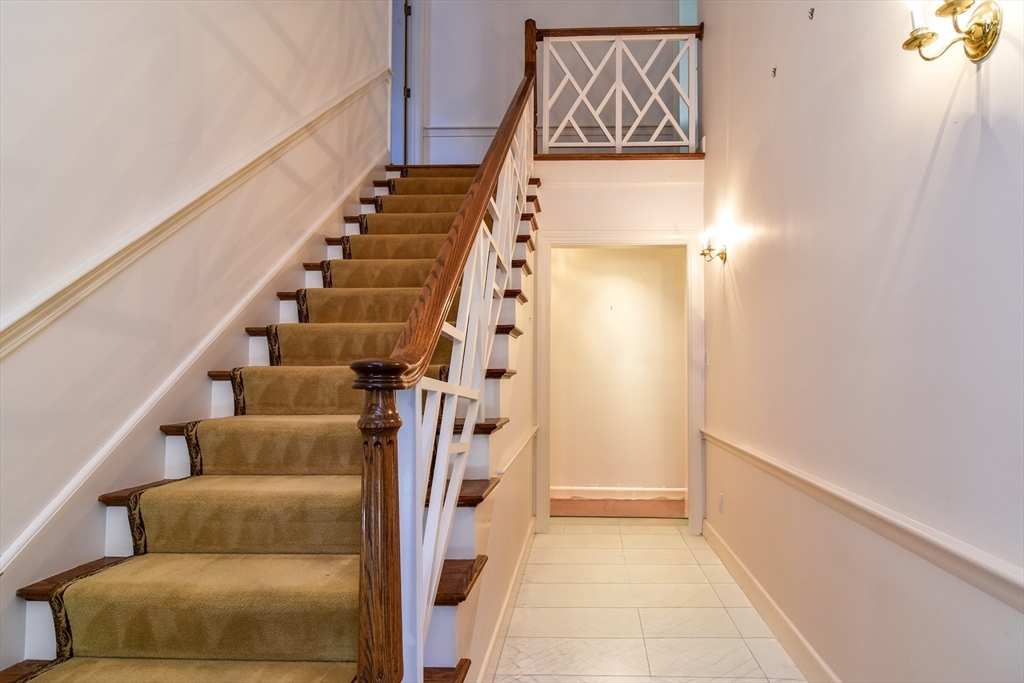 9 Buttercup Lane Dover, MA 02030 - Photo 17 of 36 a view of hallway with stairs and wooden floor