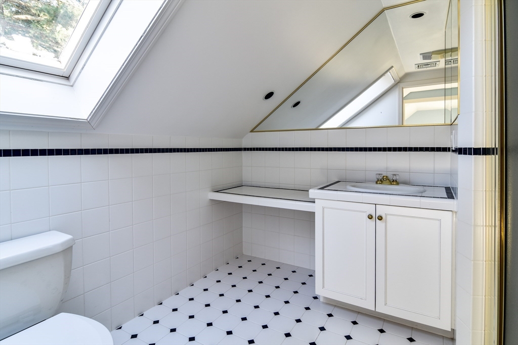 9 Buttercup Lane Dover, MA 02030 - Photo 20 of 36 a bathroom with a sink a toilet and a mirror
