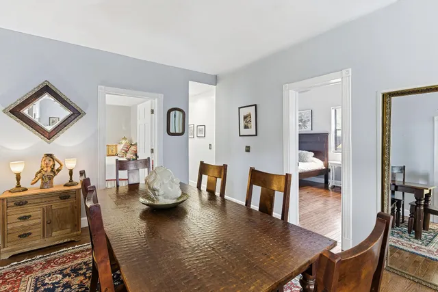 a kitchen with granite countertop wooden cabinets a refrigerator a stove a sink and dishwasher with wooden floor