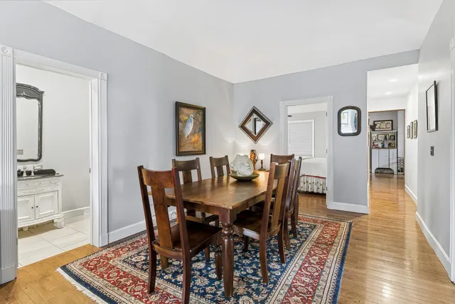 a kitchen with a table chairs and refrigerator