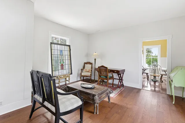 a bedroom with a bed and a dresser with mirror