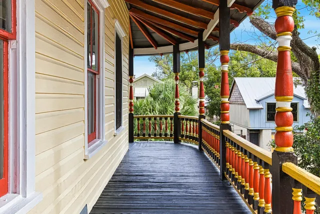 a view of a white house with a yard and garage