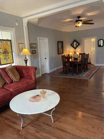 a living room with furniture and a lamps
