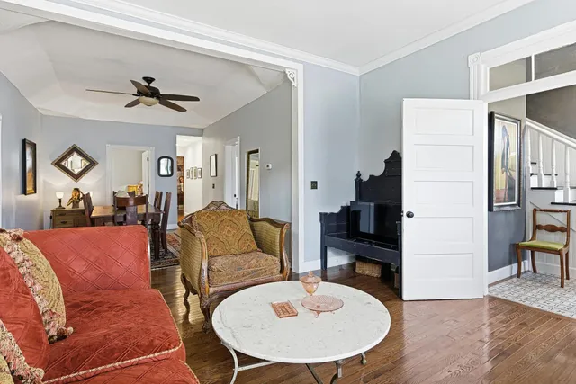 a living room with furniture and wooden floor