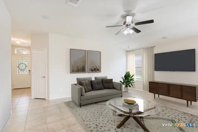 a living room with furniture a flat screen tv and a large window