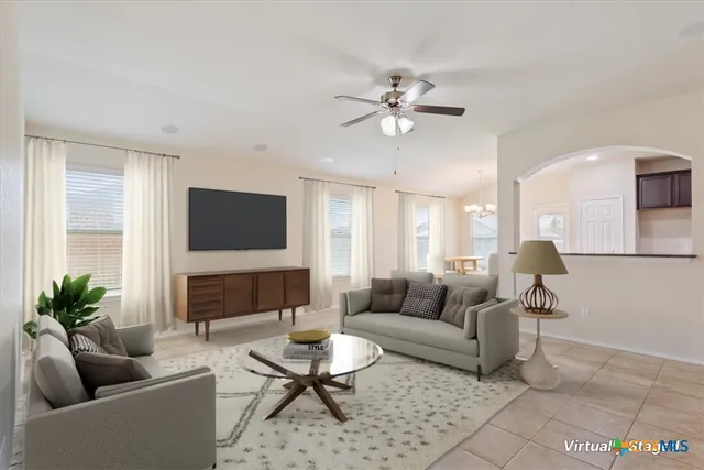 a living room with furniture and a view of kitchen