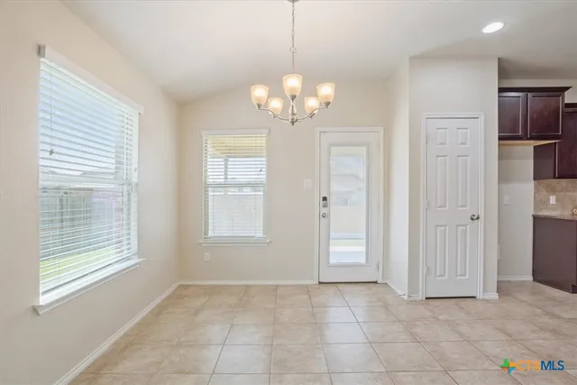 a stove top oven sitting inside of a kitchen