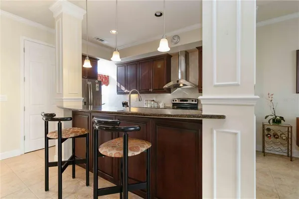 a kitchen with a table chairs sink and cabinets