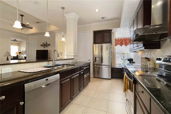 a kitchen with stainless steel appliances a sink stove and refrigerator