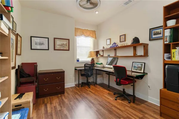 a view of a workspace with furniture and a window
