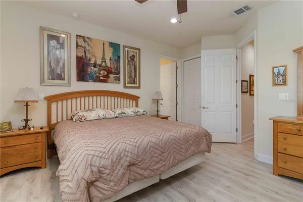 a bedroom with a bed and a night stand