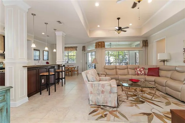 a living room with lots of furniture and a large window