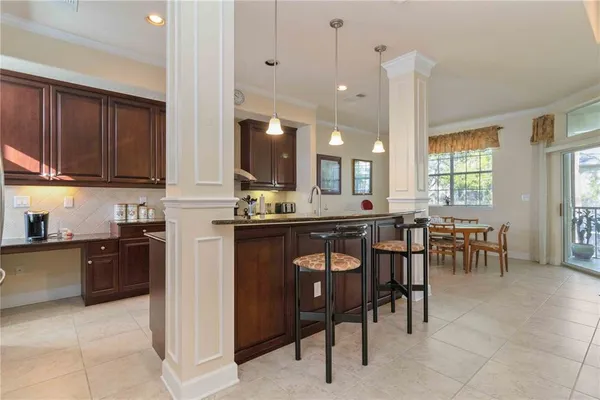 a open kitchen with stainless steel appliances granite countertop a stove top oven a sink a counter top space and cabinets