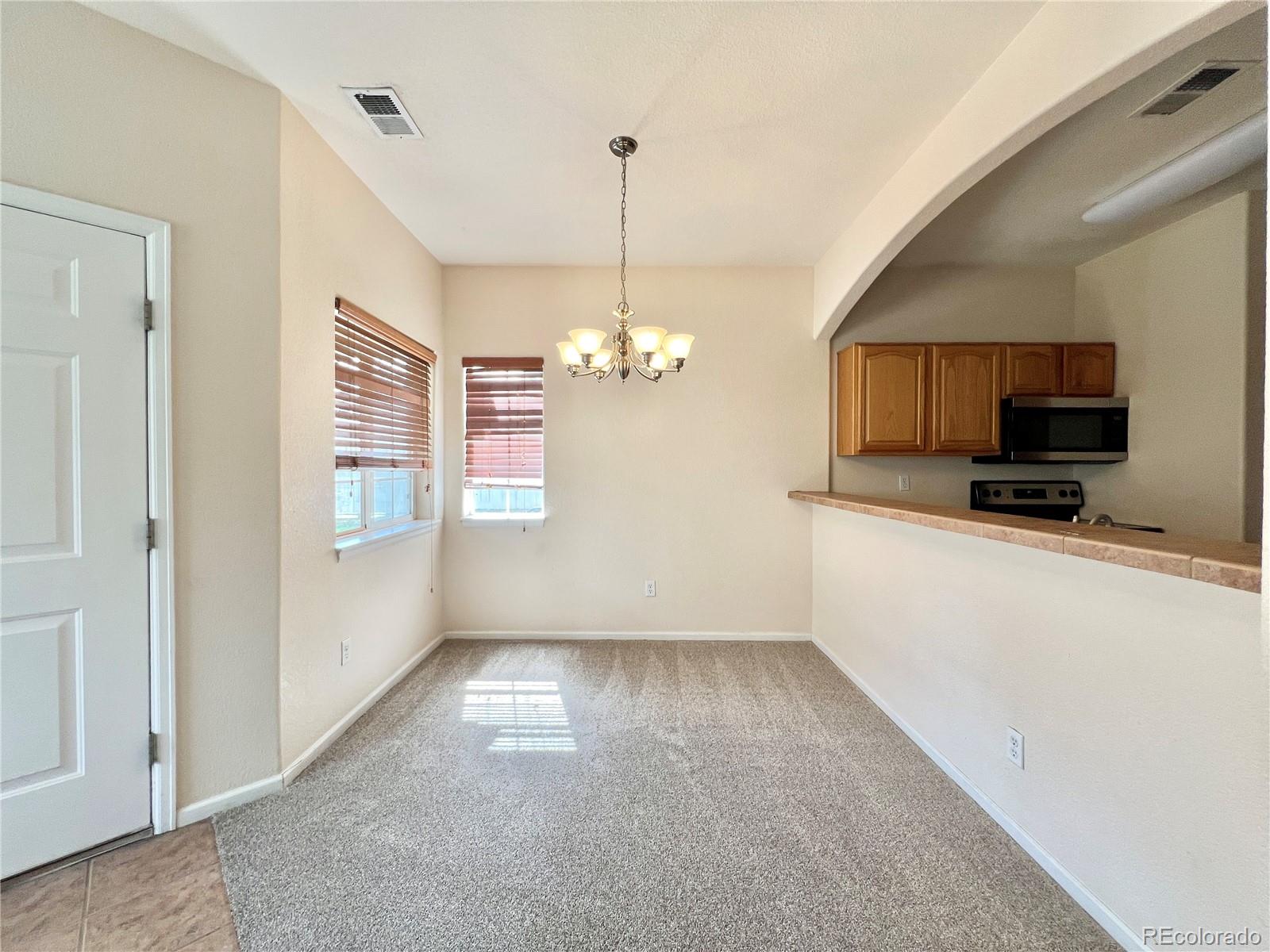 1385 South Chambers Road, Unit 102 Aurora, CO 80017 - Photo 5 of 20 a view of a kitchen with microwave and cabinets