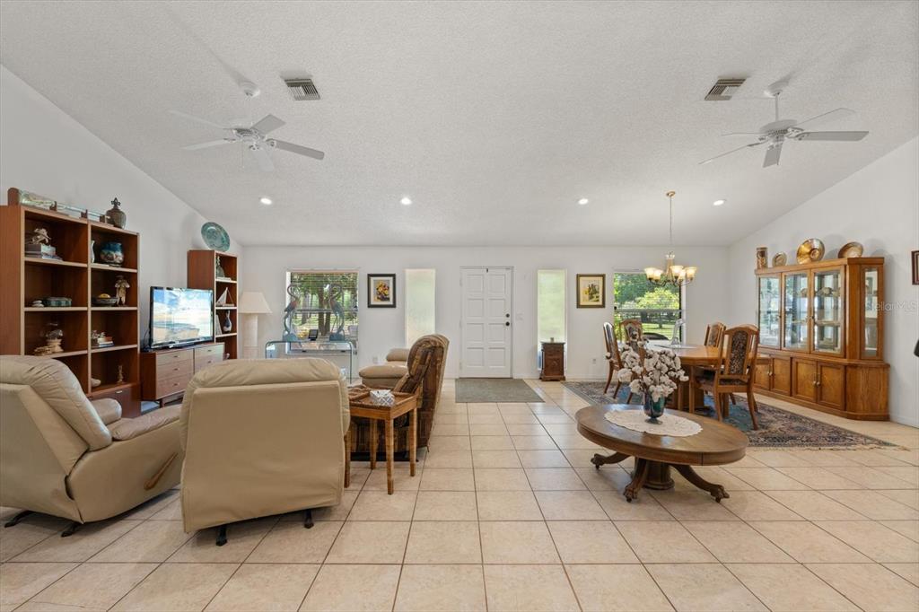 13719 Seminole Trail Wimauma, FL 33598 - Photo 12 of 68 a living room with furniture and a book shelf