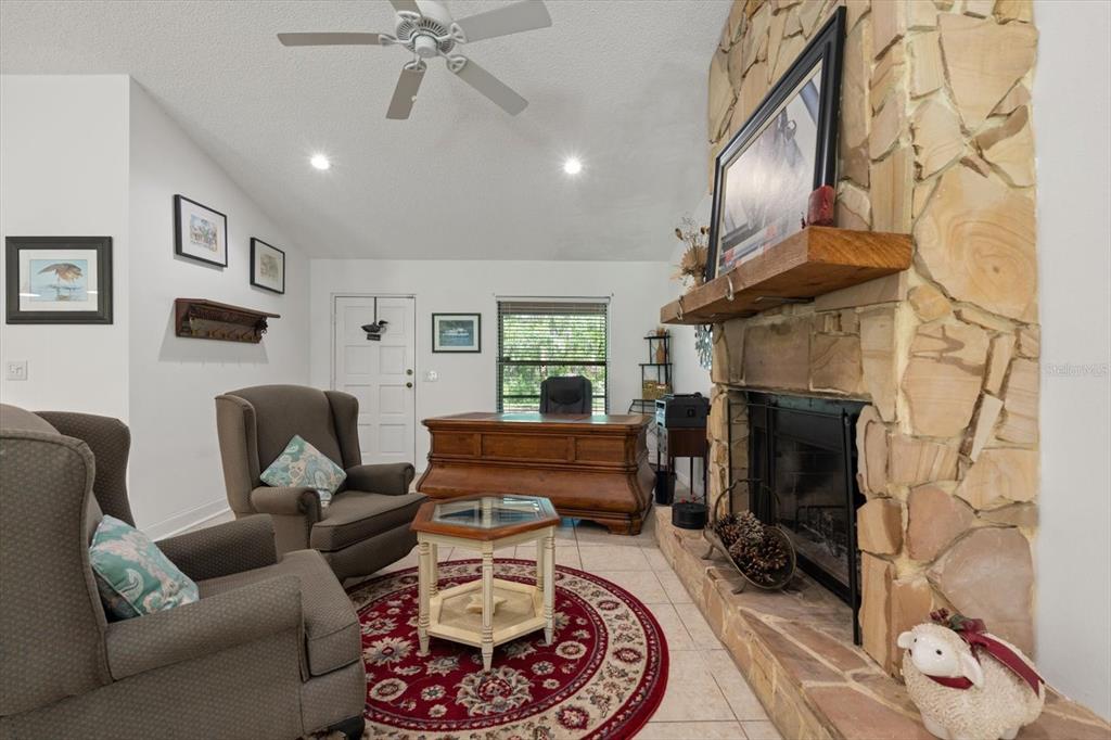 13719 Seminole Trail Wimauma, FL 33598 - Photo 17 of 68 a living room with furniture and a fireplace