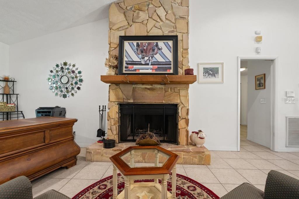 13719 Seminole Trail Wimauma, FL 33598 - Photo 18 of 68 a living room with furniture and a fireplace