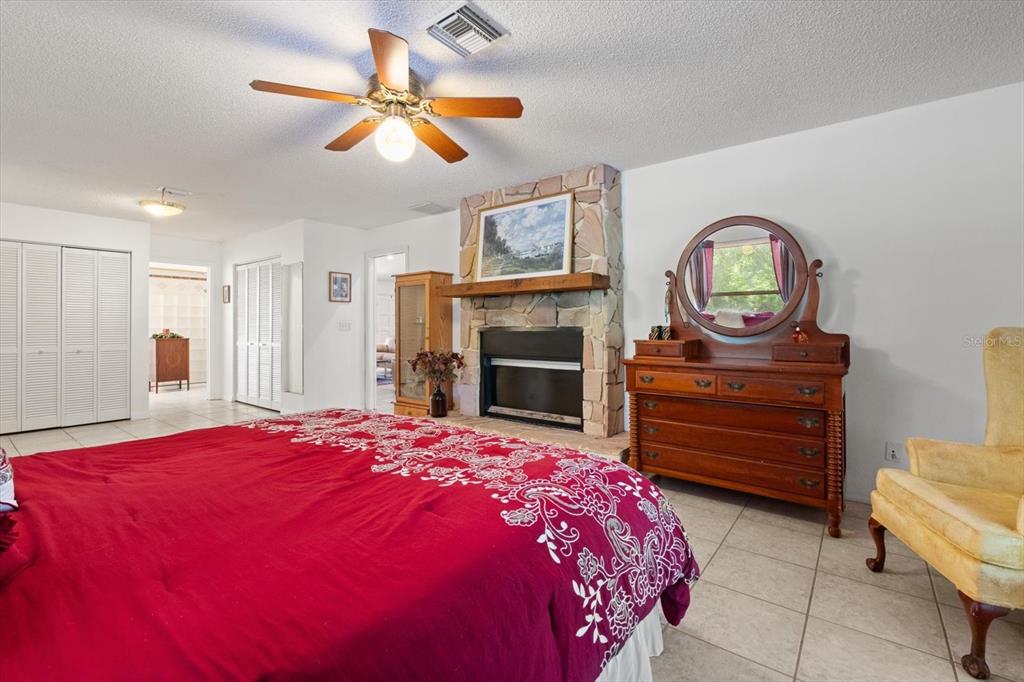 13719 Seminole Trail Wimauma, FL 33598 - Photo 20 of 68 a bedroom with a bed and a dresser