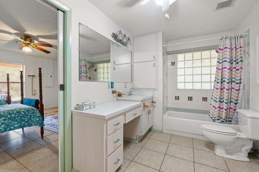 13719 Seminole Trail Wimauma, FL 33598 - Photo 27 of 68 a bathroom with a sink a toilet and shower