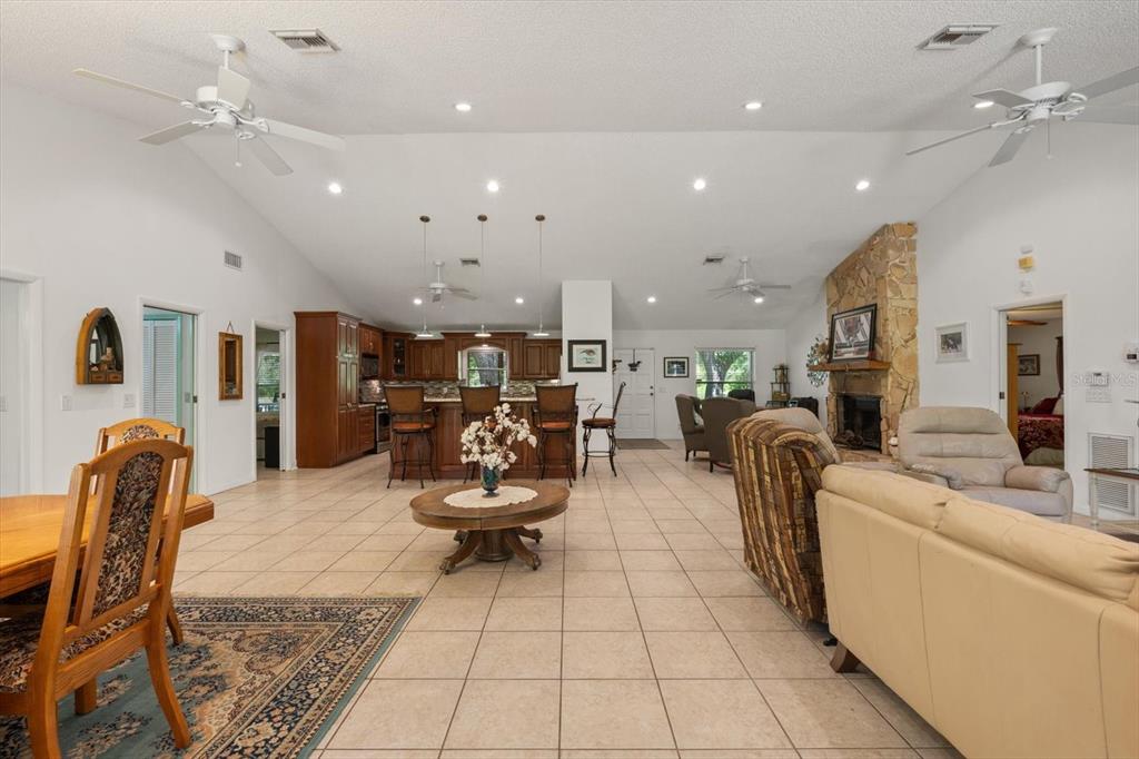 13719 Seminole Trail Wimauma, FL 33598 - Photo 4 of 68 a living room with patio furniture and kitchen view