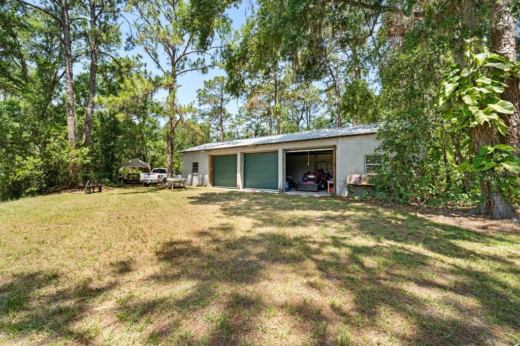 13719 Seminole Trail Wimauma, FL 33598 - Photo 50 of 68 a view of house with backyard and trees