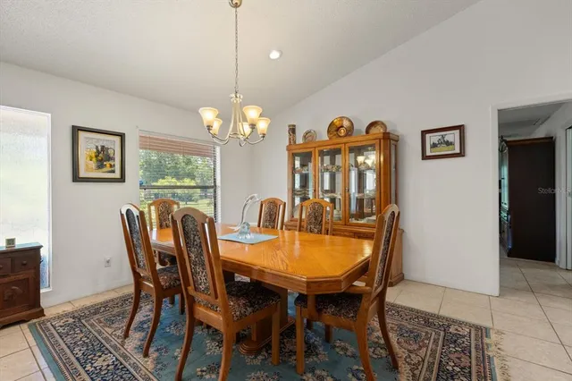 a open kitchen with stainless steel appliances kitchen island granite countertop a refrigerator cabinets and chairs