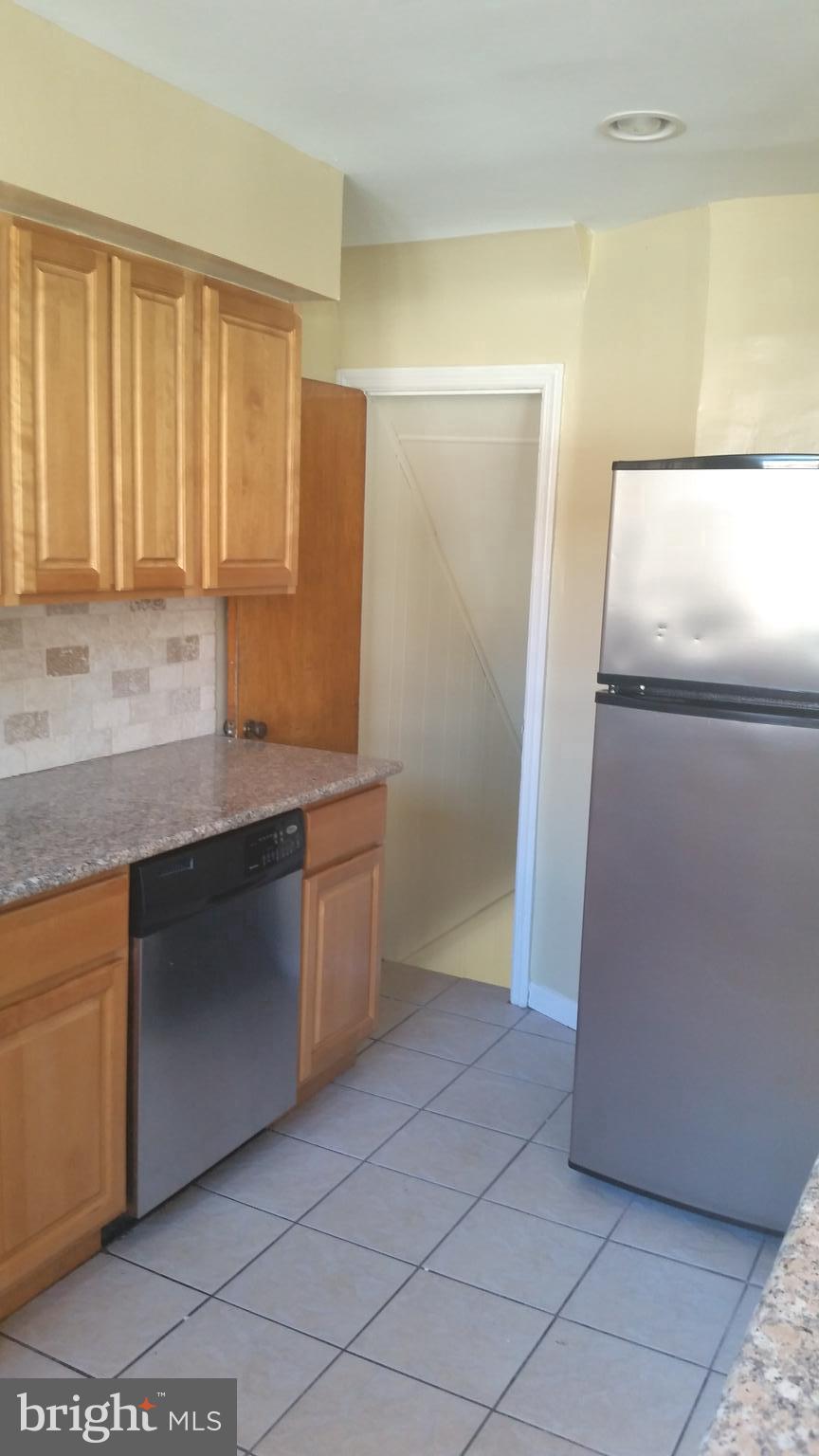 3612 Winona Street Philadelphia, PA 19129 - Photo 3 of 10 a kitchen with granite countertop a refrigerator and a sink