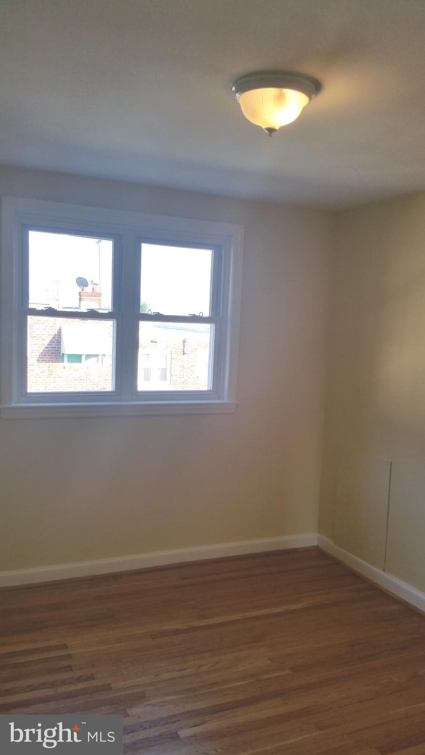3612 Winona Street Philadelphia, PA 19129 - Photo 7 of 10 a view of an empty room with wooden floor and a window