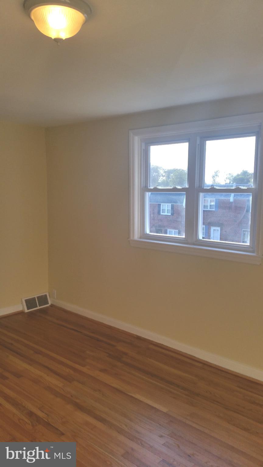 3612 Winona Street Philadelphia, PA 19129 - Photo 8 of 10 a view of an empty room with wooden floor and a window