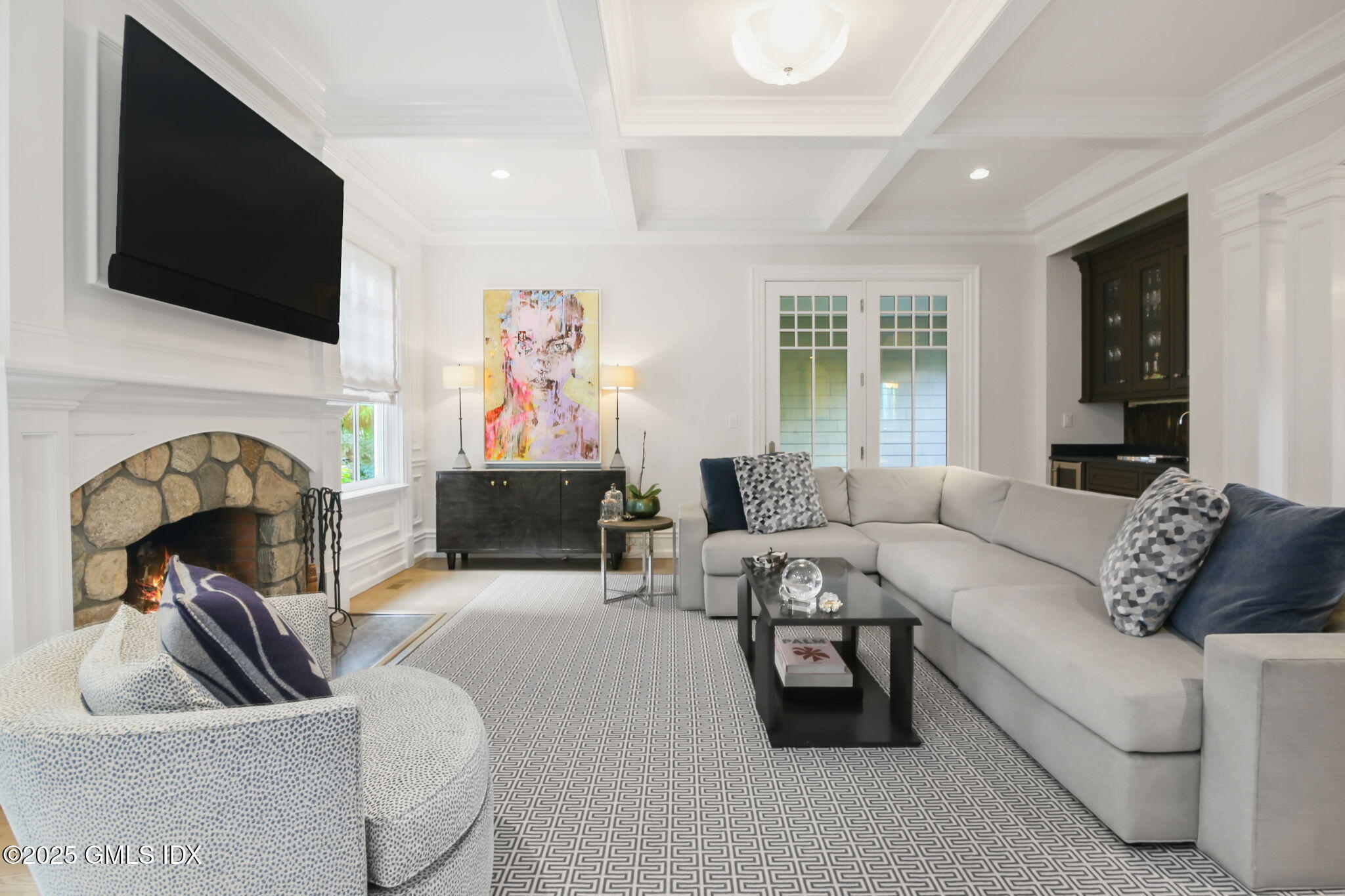 50 Sound View Drive, Unit 4N Greenwich, CT 06830 - Photo 4 of 20 a living room with furniture a flat screen tv and a fireplace