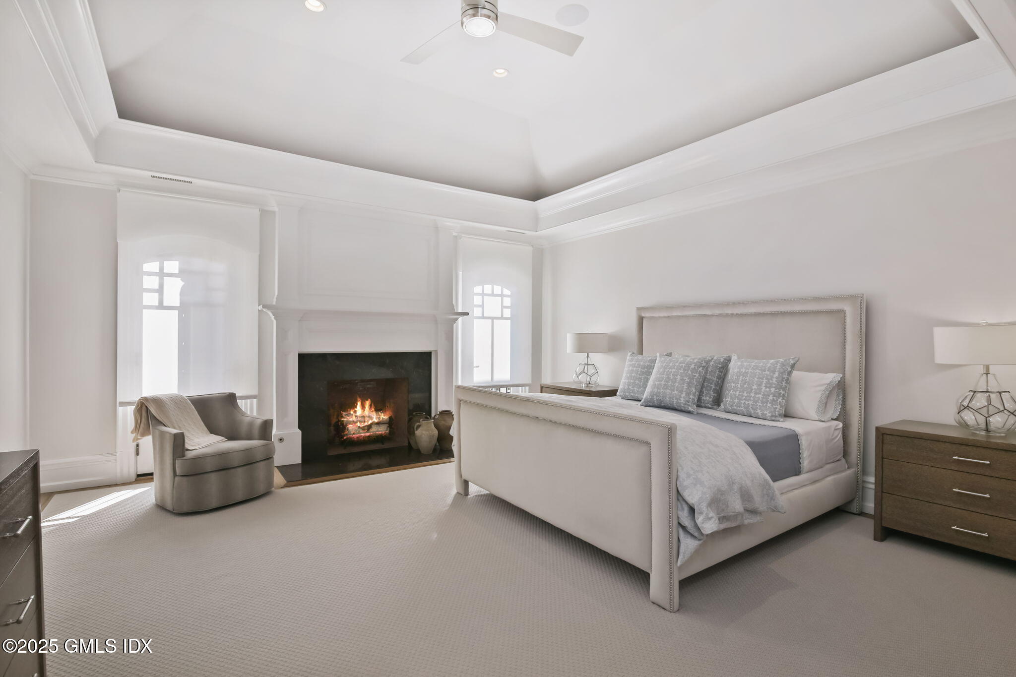 50 Sound View Drive, Unit 4N Greenwich, CT 06830 - Photo 9 of 20 a spacious bedroom with a bed and a fireplace