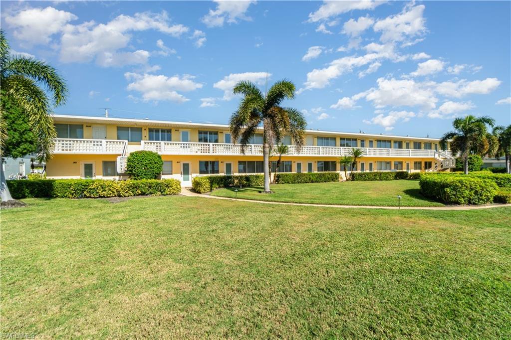473 12th Avenue South, Unit B11 Naples, FL 34102 - Photo 16 of 18 a front view of a house with a yard