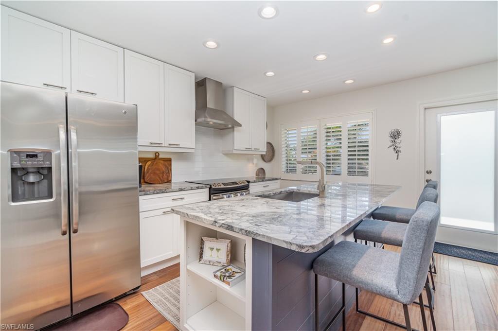473 12th Avenue South, Unit B11 Naples, FL 34102 - Photo 2 of 18 a kitchen with stainless steel appliances granite countertop a sink stove and refrigerator