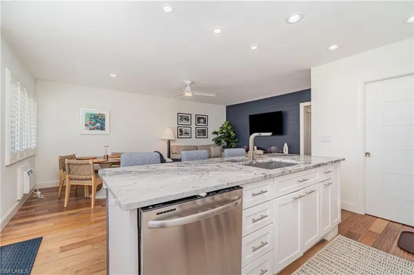 a dining room with furniture a rug and a flat screen tv