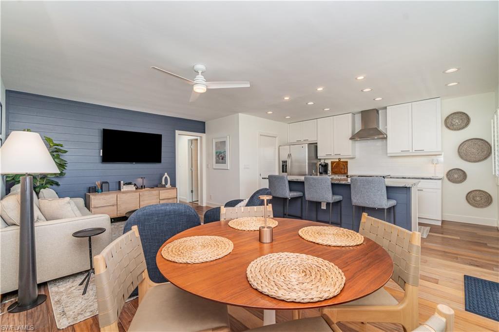 473 12th Avenue South, Unit B11 Naples, FL 34102 - Photo 7 of 18 a dining room with furniture a rug and a flat screen tv